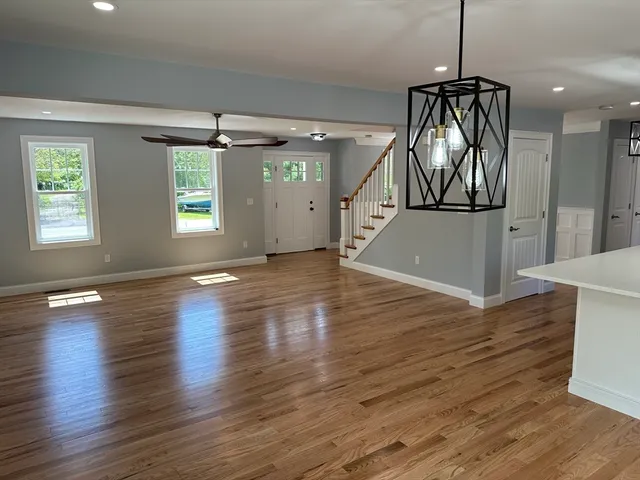 a view of empty room with wooden floor and fireplace