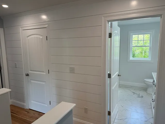 a view of an empty room and a ceiling fan