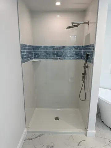 a bathroom with a bathtub and a shower