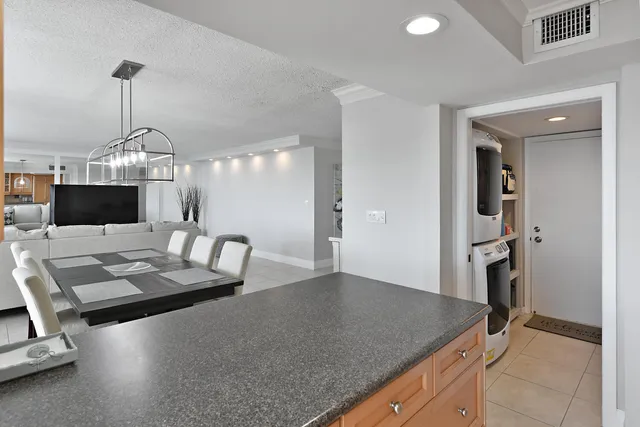a kitchen with a table chairs and refrigerator