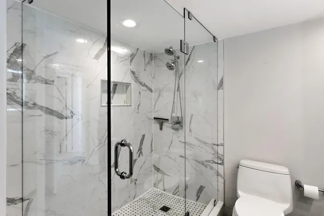 a bathroom with a shower toilet and sink