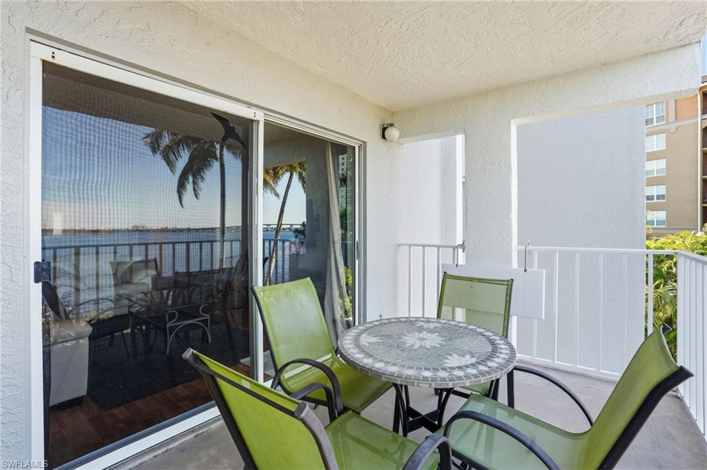 2875 Palm Beach Boulevard, Unit 202 Fort Myers, FL 33916 - Photo 11 of 38 a view of a dining room with furniture and wooden floor