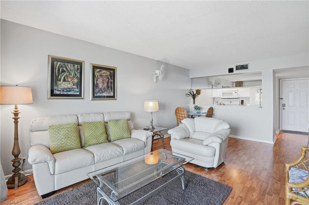 2875 Palm Beach Boulevard, Unit 202 Fort Myers, FL 33916 - Photo 12 of 38 a living room with furniture and a wooden floor