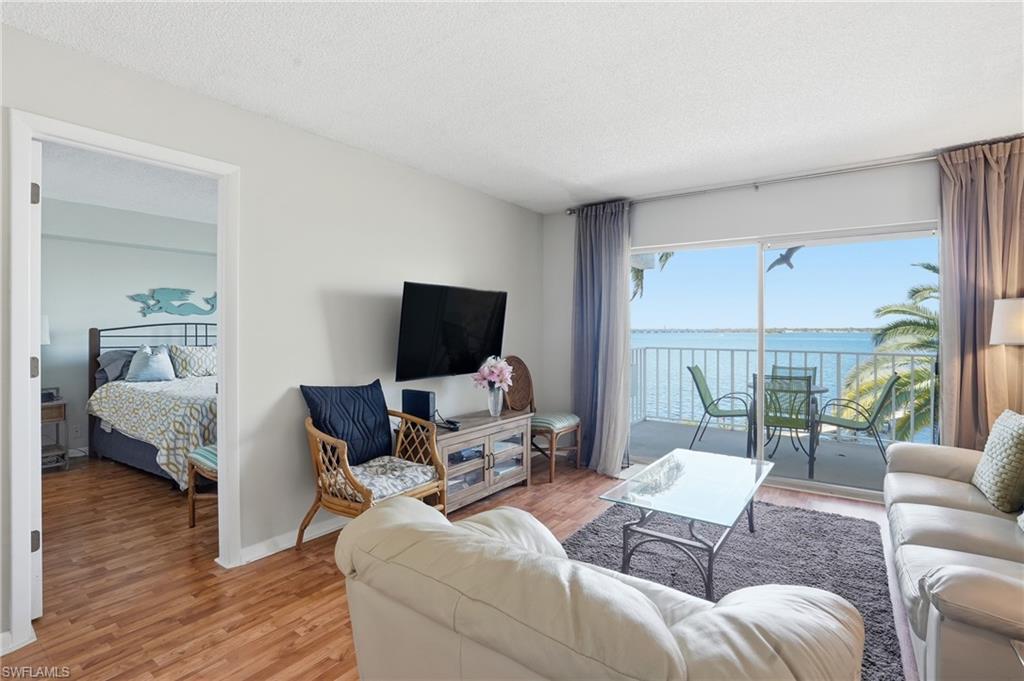 2875 Palm Beach Boulevard, Unit 202 Fort Myers, FL 33916 - Photo 19 of 38 a living room with furniture and a flat screen tv