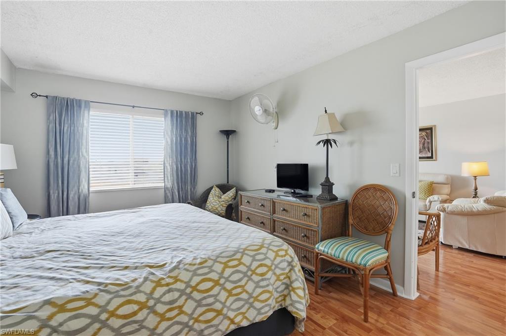 2875 Palm Beach Boulevard, Unit 202 Fort Myers, FL 33916 - Photo 21 of 38 a bedroom with a bed and a chair