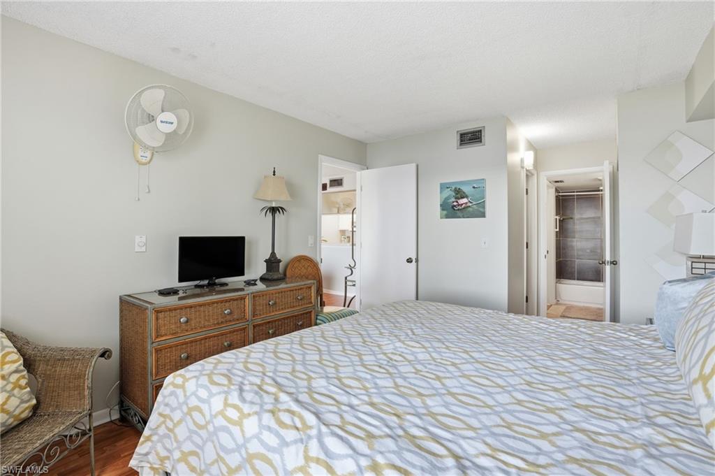 2875 Palm Beach Boulevard, Unit 202 Fort Myers, FL 33916 - Photo 22 of 38 a bedroom with a bed and a flat screen tv