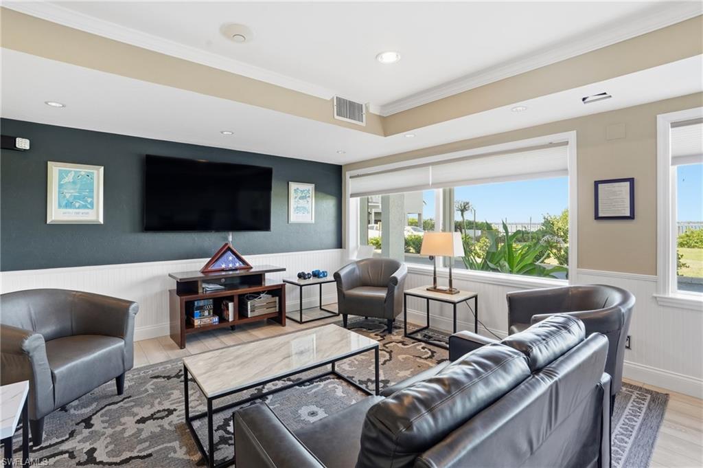 2875 Palm Beach Boulevard, Unit 202 Fort Myers, FL 33916 - Photo 30 of 38 a living room with furniture and a flat screen tv