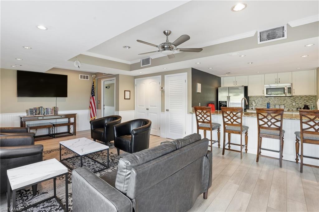 2875 Palm Beach Boulevard, Unit 202 Fort Myers, FL 33916 - Photo 32 of 38 a living room with furniture and a flat screen tv