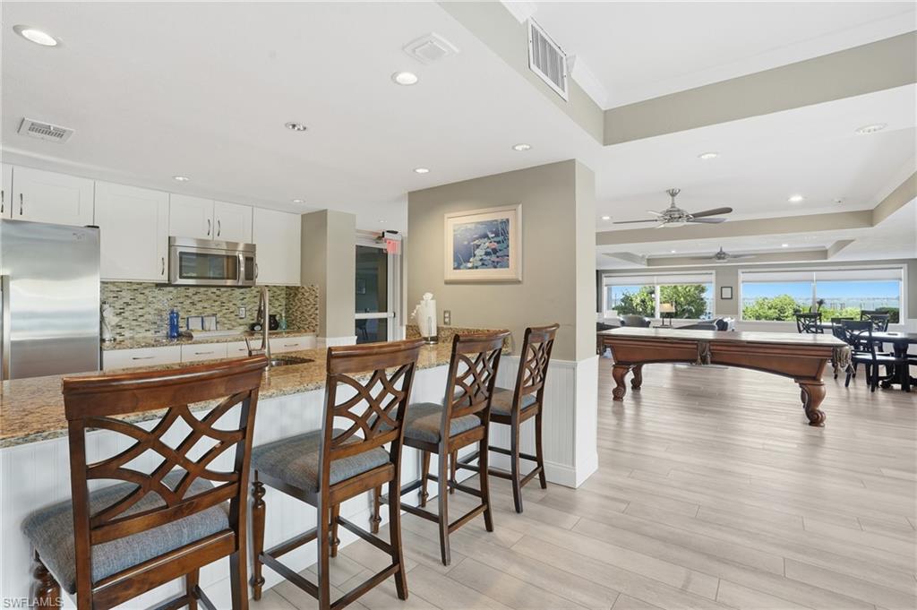 2875 Palm Beach Boulevard, Unit 202 Fort Myers, FL 33916 - Photo 33 of 38 a dining area with furniture and a view of kitchen