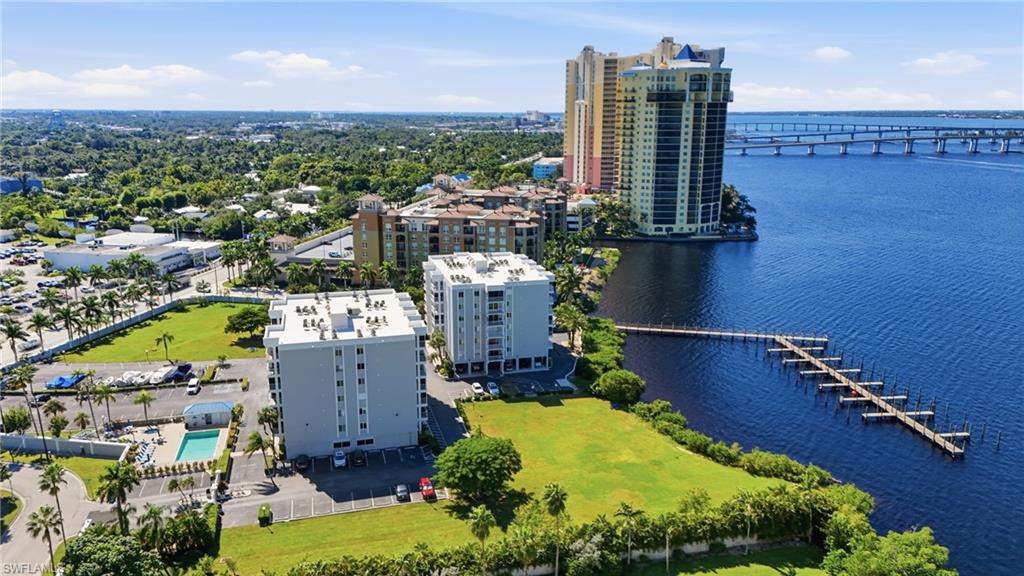2875 Palm Beach Boulevard, Unit 202 Fort Myers, FL 33916 - Photo 35 of 38 an aerial view of a house with a swimming pool outdoor seating and yard