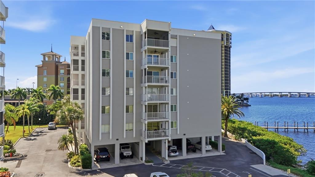 2875 Palm Beach Boulevard, Unit 202 Fort Myers, FL 33916 - Photo 4 of 38 a front view of a building with glass windows and plants