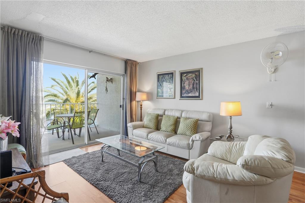 2875 Palm Beach Boulevard, Unit 202 Fort Myers, FL 33916 - Photo 8 of 38 a living room with furniture and a potted plant