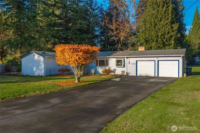 a front view of house with yard and trees