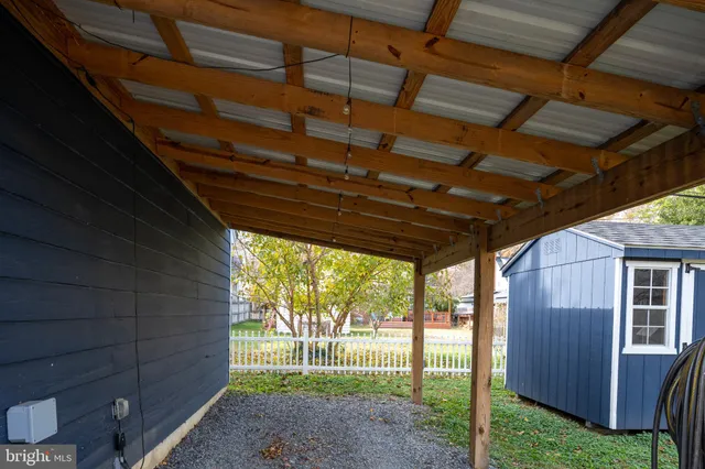 a view of entryway with wooden floor and stairs