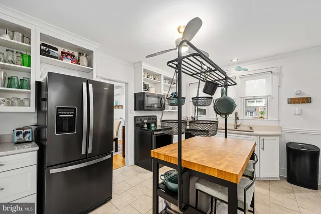 a kitchen with stainless steel appliances cabinets and wooden floor