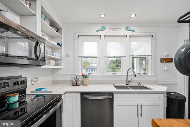 a view of a dining room with furniture and a floor to ceiling window