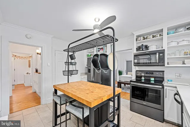 a bathroom with a sink a toilet a shower and a window