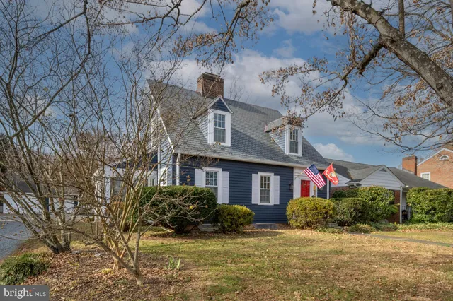 a view of a house with brick walls and potted plants