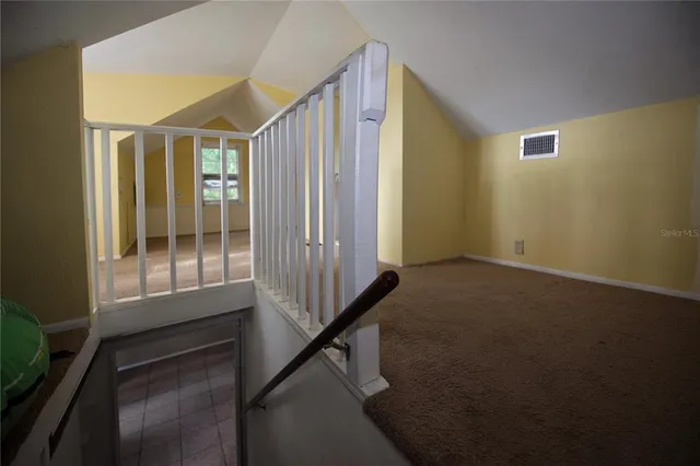a view of a hallway with entryway and livingroom