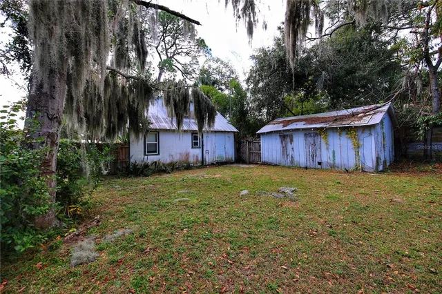 an aerial view of a house with a yard and garden