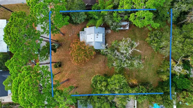 an aerial view of a residential houses with outdoor space and river