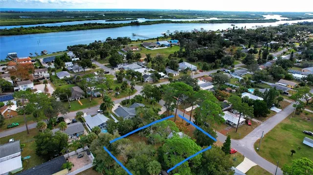 an aerial view of a house with a yard