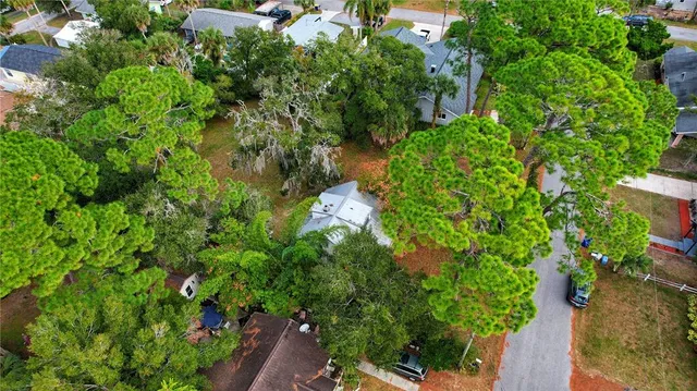 an aerial view of house with yard and outdoor seating