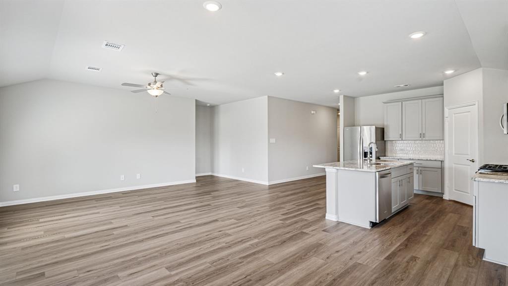 2120 Rannoch Street Sherman, TX 75092 - Photo 13 of 36 a kitchen with stainless steel appliances granite countertop a sink stove and refrigerator