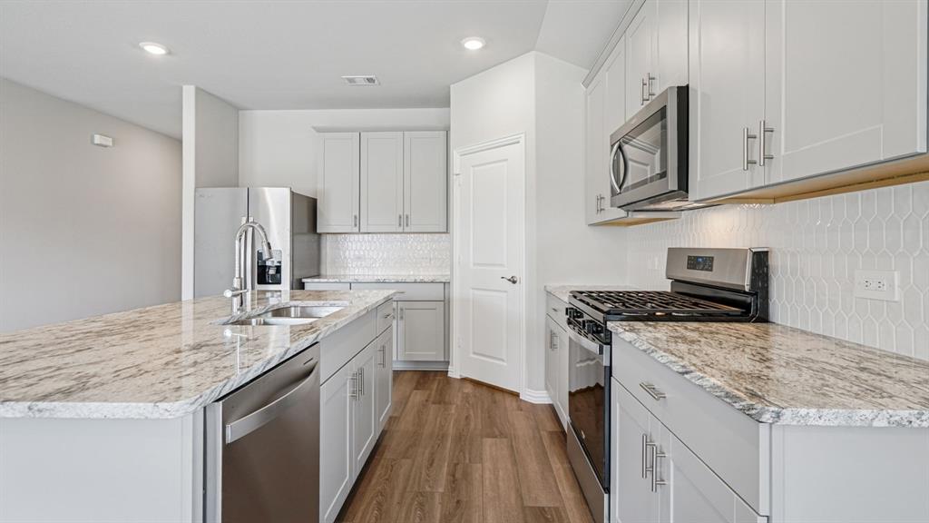 2120 Rannoch Street Sherman, TX 75092 - Photo 4 of 36 a kitchen with stainless steel appliances granite countertop a sink stove and refrigerator
