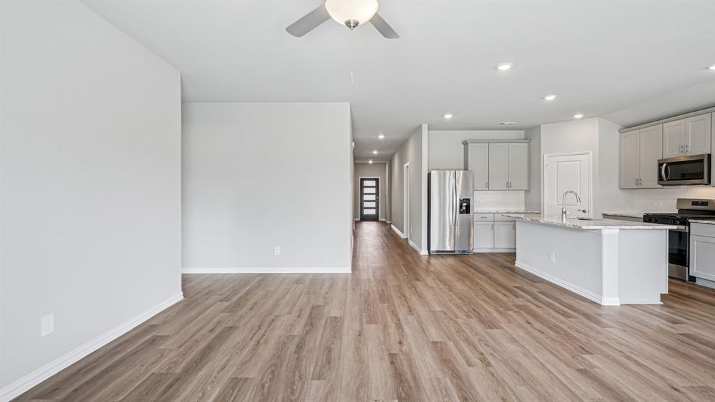 2120 Rannoch Street Sherman, TX 75092 - Photo 7 of 36 a view of kitchen with wooden floor electronic appliances and window