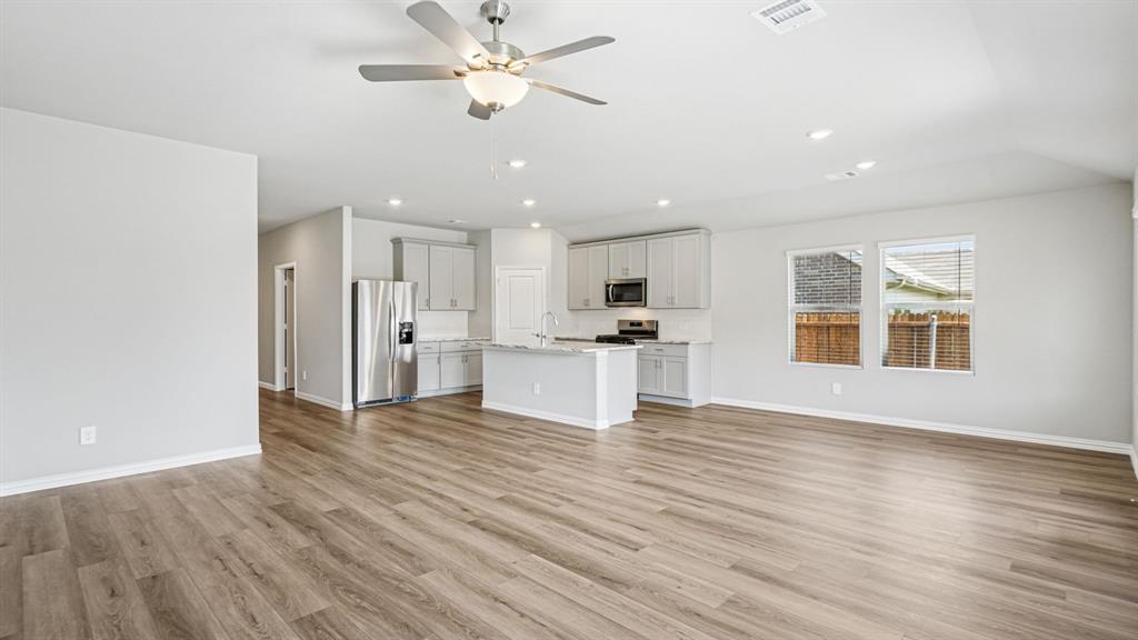 2120 Rannoch Street Sherman, TX 75092 - Photo 8 of 36 a view of an empty room with wooden floor and a window