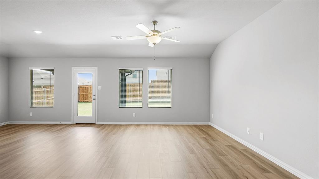 2120 Rannoch Street Sherman, TX 75092 - Photo 9 of 36 an empty room with wooden floor and windows