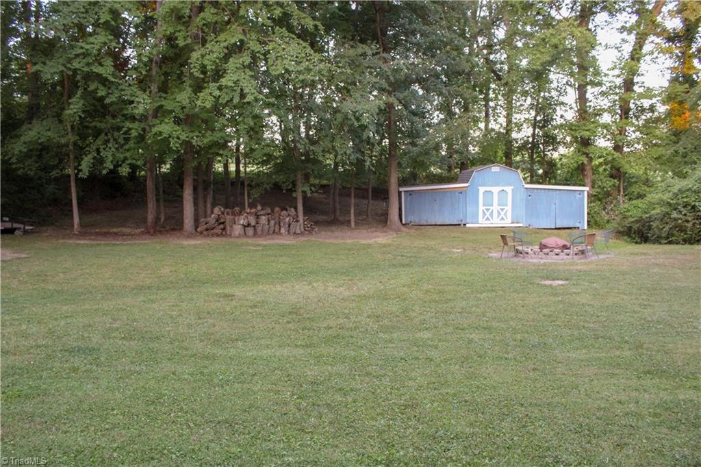 1612 Penny Road High Point, NC 27265 - Photo 39 of 46 Backyard features Firepit + Storage Building With Brand New Roof & Currently Getting a New Coat of Paint