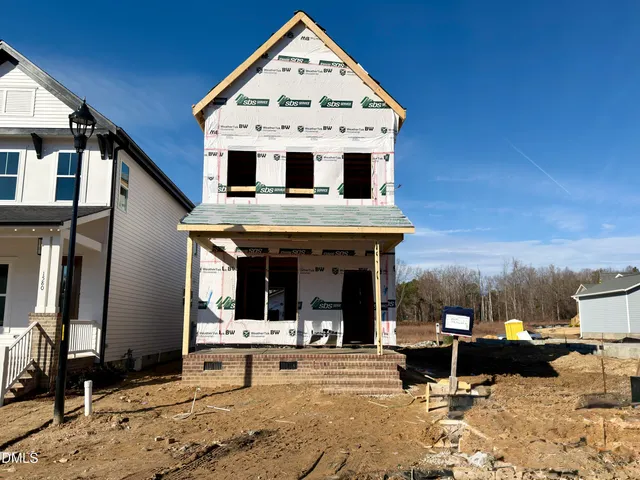 a view of a white house with large windows