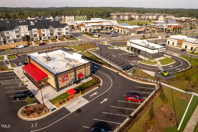 an aerial view of residential houses with outdoor space