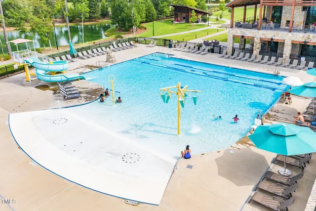 swimming pool view with a seating space