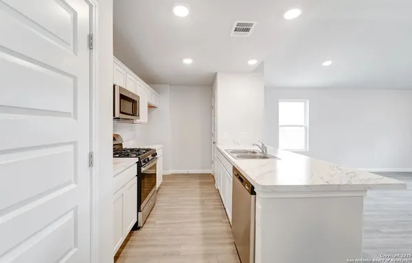 a kitchen with a sink stove and refrigerator