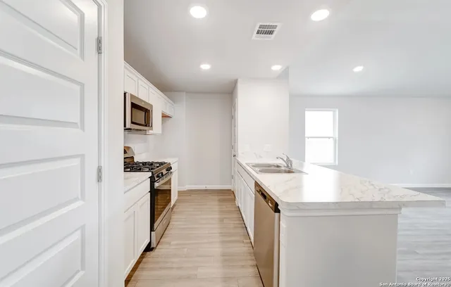 a kitchen with a sink stove and refrigerator