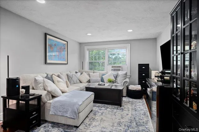 a living room with furniture large window and a flat screen tv