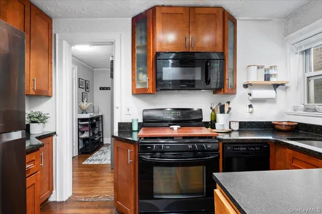 a kitchen with stainless steel appliances granite countertop a stove a sink and a microwave