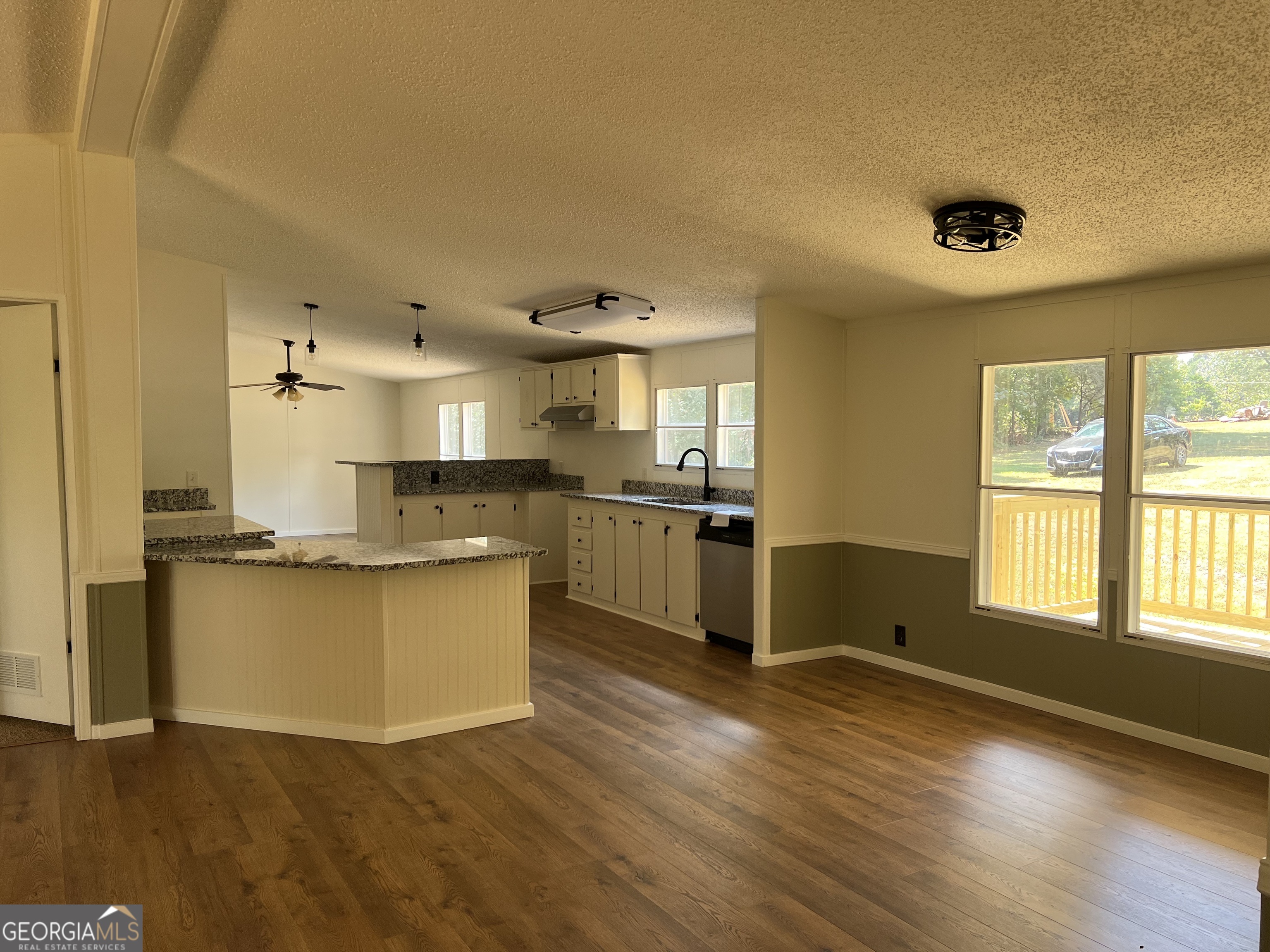 178 Edna Circle Thomaston, GA 30286 - Photo 12 of 31 a kitchen with stainless steel appliances granite countertop a sink and a wooden floors