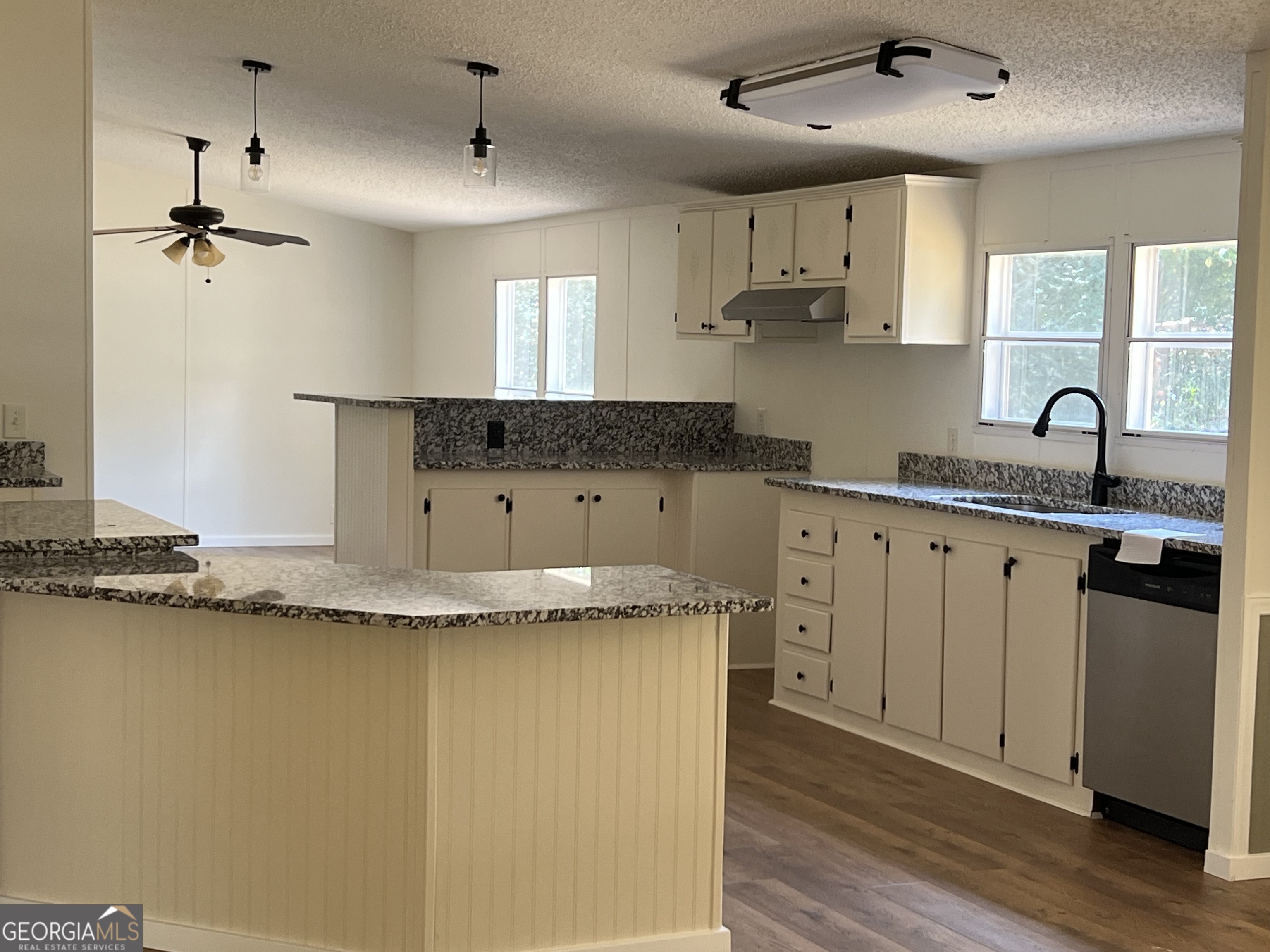 178 Edna Circle Thomaston, GA 30286 - Photo 13 of 31 a kitchen with granite countertop cabinets a sink a window and stainless steel appliances