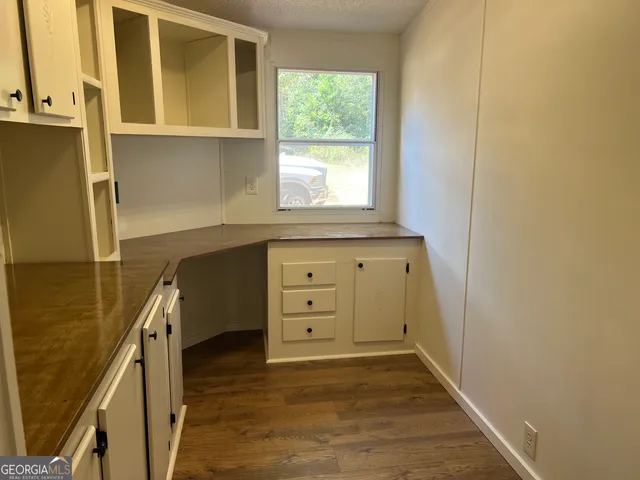a kitchen with granite countertop white cabinets and sink