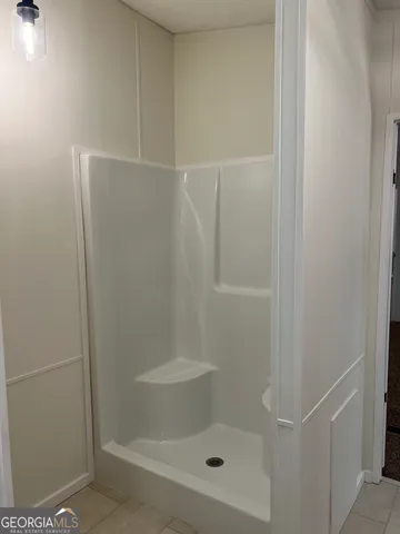a bathroom with a shower and a toilet