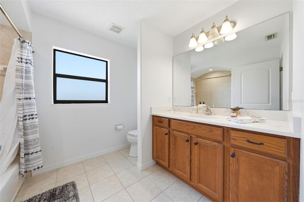 14433 Lake Yale Road Umatilla, FL 32784 - Photo 21 of 38 a bathroom with a double vanity sink mirror and toilet