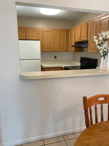 a view of kitchen with furniture and wooden floor