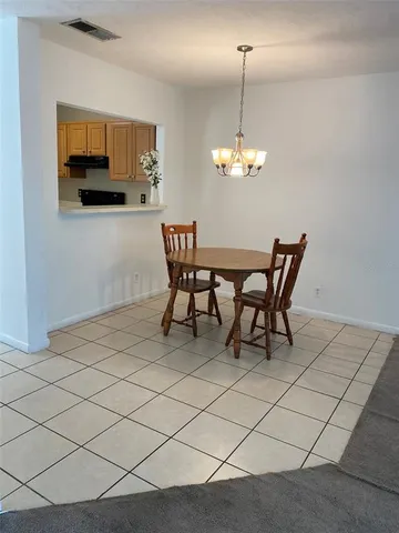 a dining room with furniture and a chandelier