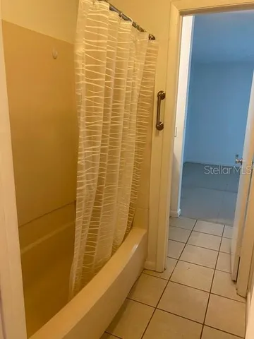 a white toilet sitting next to a shower