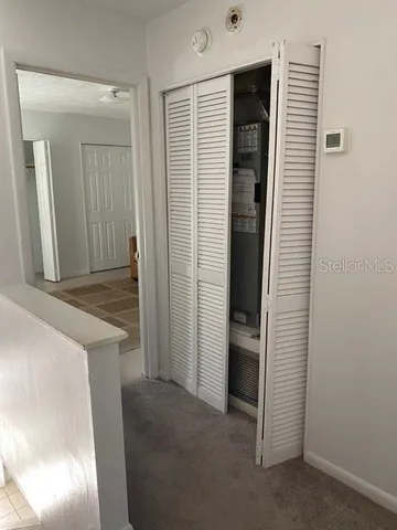 a living room with a couch and a stove with wooden floor