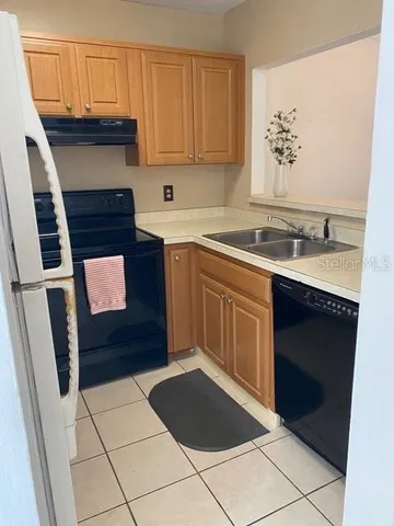 a kitchen with a sink a stove and cabinets